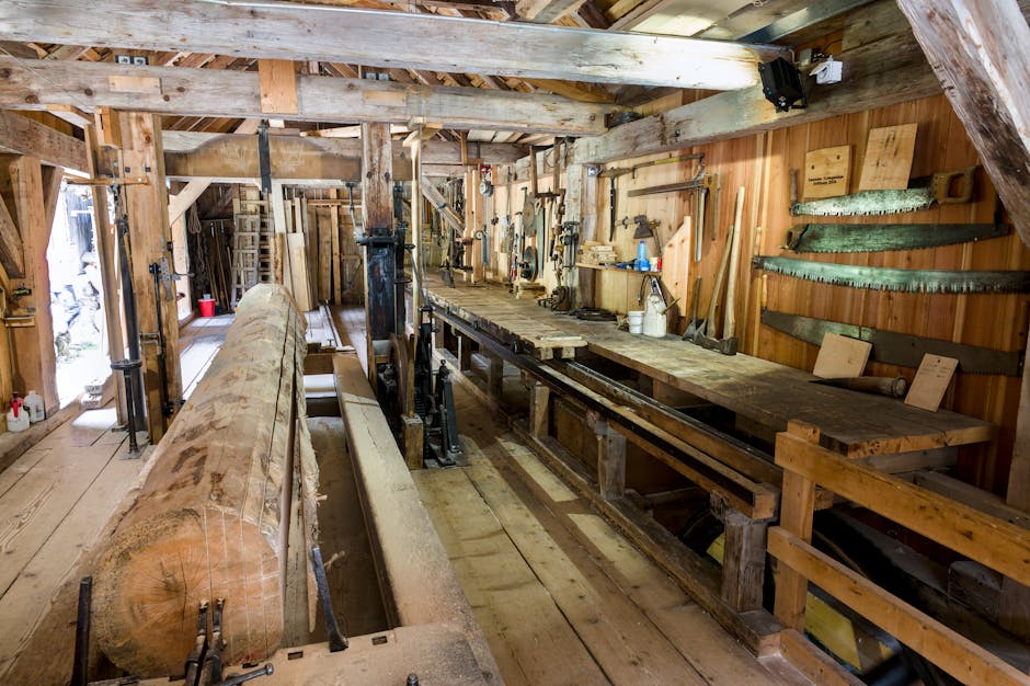 Interior of a traditional Swiss sawmill with wooden beams and vintage tools.