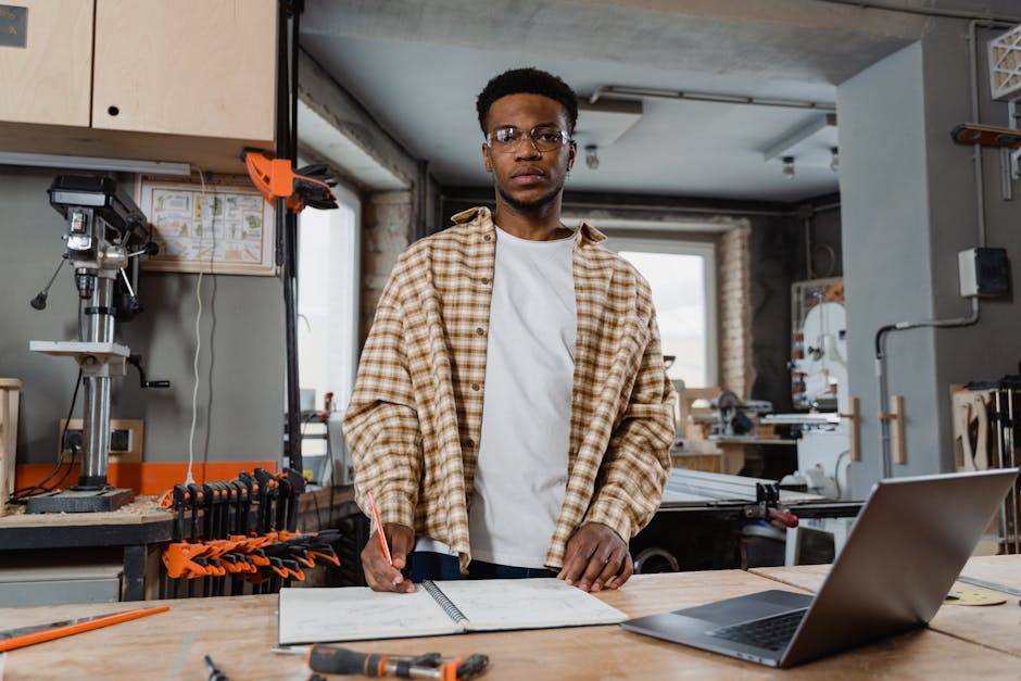 Professional woodworker in workshop, crafting plans with tools, showcasing woodworking skills.